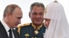 Зліва направо: російський президент Володимир Путін, міністр оборони Росії Сергій Шойгу та Московський патріарх Кирило